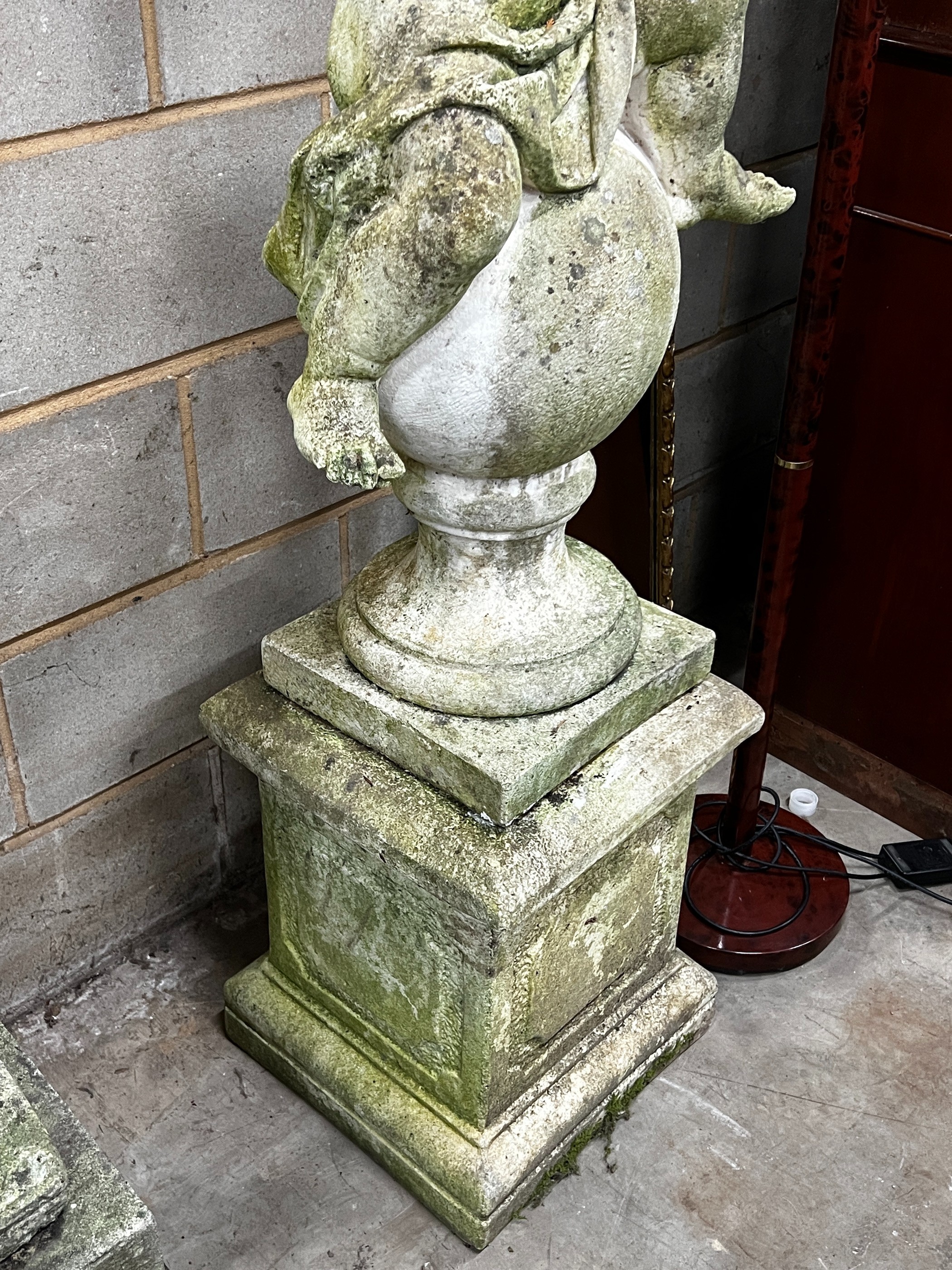 A large weathered reconstituted stone figure, a seated nymph on socle on a plinth base, height 148cm